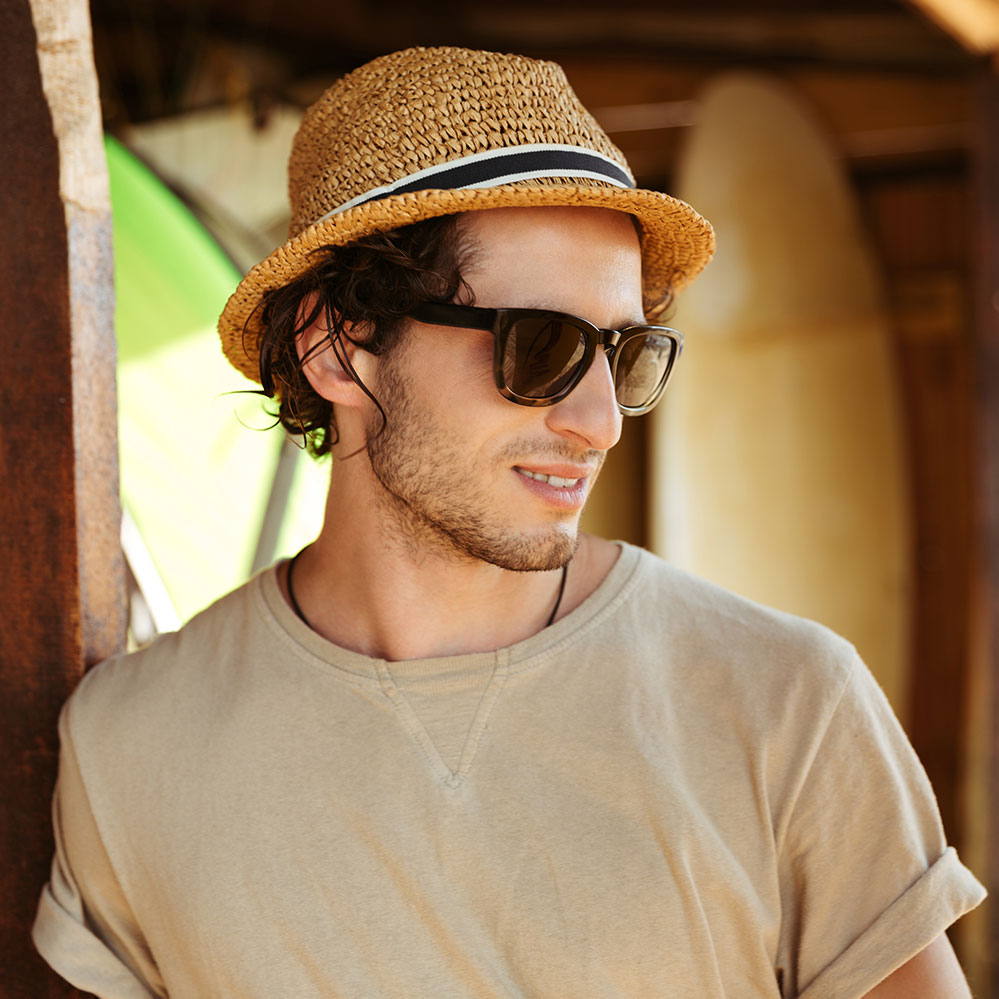 close-up-portrait-of-a-man-in-sunglasses-and-hat-PQHGFYQ-1.jpg