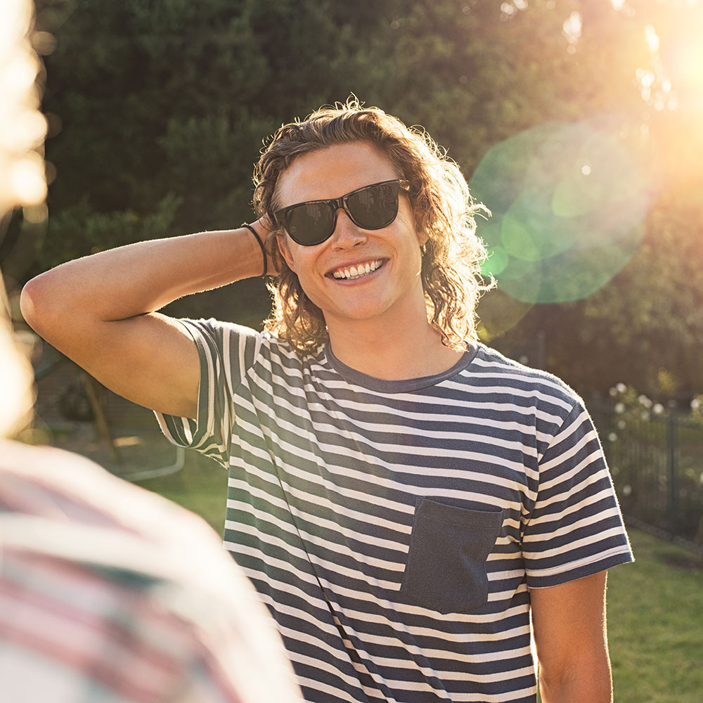 young-man-with-sunglasses-at-park-784T3HL-1.jpg